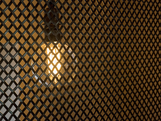 industrial mesh with oversize lightbulb behing